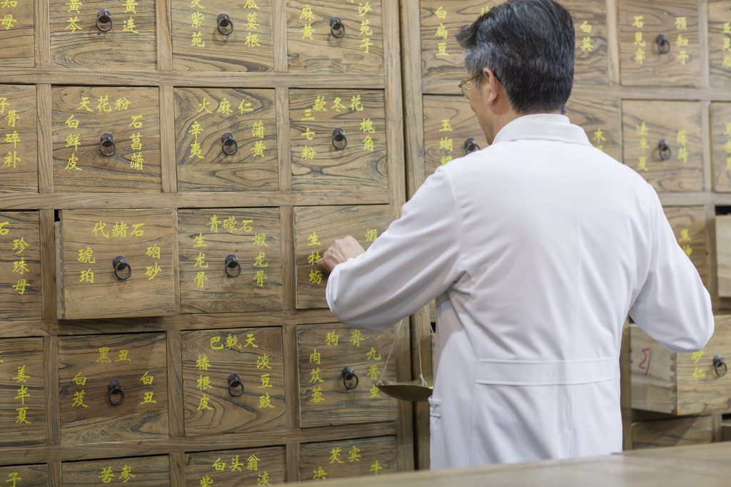 Senior Chinese doctor fill the prescription